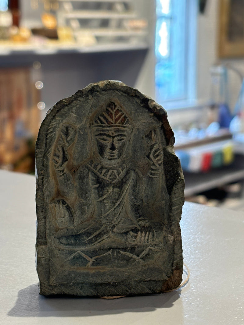 Hand-carved Stone Buddha under Archway