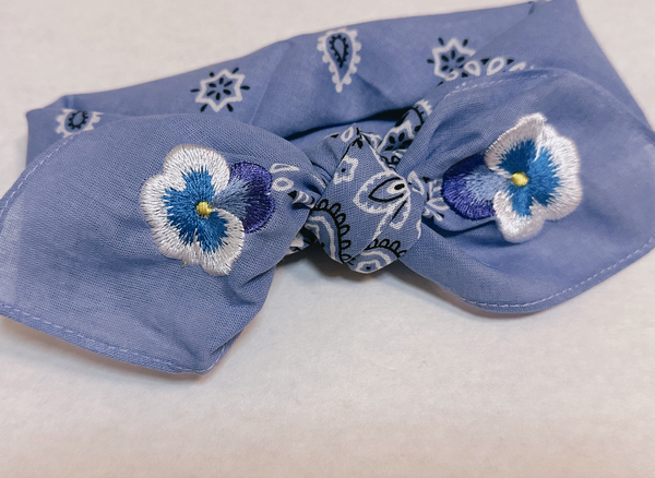 Purple bandana with embroidered pansies in corner